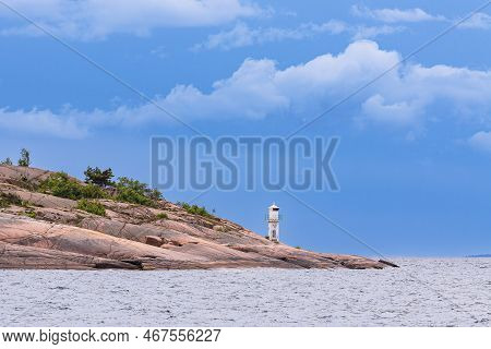 Baltic Sea Coast With Rocks And Lighthouse On The Island Blå Jungfrun In Sweden.