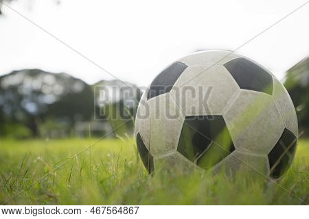 A Ball For Street Soccer Football Under The Sunset Ray Light In Grass  Field Area With Abstract Ligh