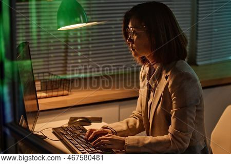 Young Woman Concentrating On Her Online Work On Computer, She Typing Codes On Keyboard Working In Of