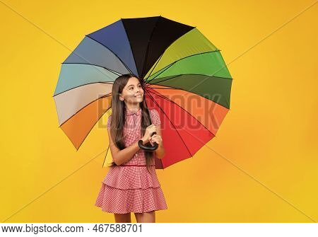 Summer Dress. Happy Teen Girl Holding Rainbow Umbella Standing Isolated On Yellow Background, Isolat