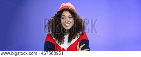 Woman With Curly Hair In Winter Beanie Feeling Uncomfortable And Discomfort Clenching Teeth And Frow