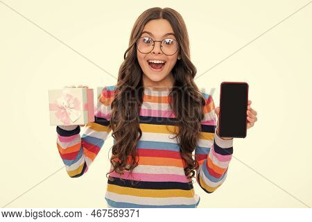 Birthday Present, Bonus For Mobile User. Portrait Of Teenager Child Girl Holding Gift Box And Cell P