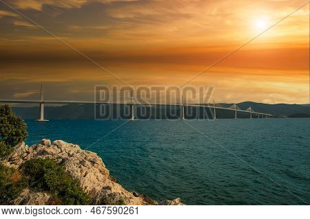 Beautiful Modern Bridge Over The Sea On Peljesac In Croatia. In The Foreground Houses And In The Bac