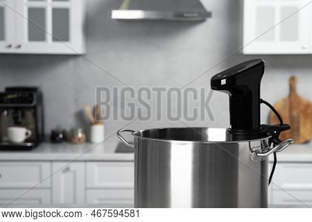 Pot With Sous Vide Cooker In Kitchen, Closeup And Space For Text. Thermal Immersion Circulator