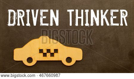 Closeup On Businessman Holding A Card With Text Driven Thinker, Business Concept Image With Soft Foc
