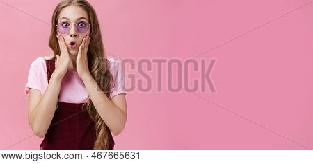 Waist-up Shot Of Sylish Young Girl With Tattoo And Wavy Pretty Natural Hairstyle Pressing Palms To C