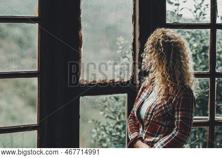 One Woman Standing Alone At Home Looking Outside The Windows At Nature Background View. Female Peopl