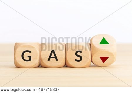 Gas Price Up Or Down Concept. Text On Wooden Blocks And Turning Dice With Up And Down Arrows. Copy S