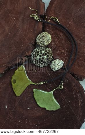 Close Up Craft Earrings With Leaves And Leather Laces Concept Photo. Top View Photography With Woode
