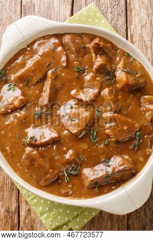 Carbonnade A La Flamande Flemish Beef Stew Closeup On The Pot On The Wooden Table. Vertical Top View