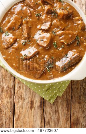 Carbonnade Flamande Is A Flemish Beef, Onion And Beer Stew Closeup In The Pot On The Wooden Table. V