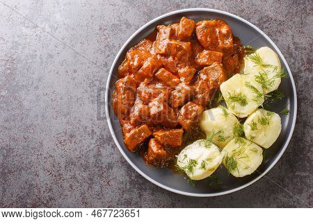 Viennese Beef Goulash With Thick Sauce Served With Boiled Potatoes Close-up On A Plate On The Table.