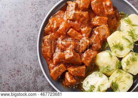Austrian Beef Goulash In A Thick Rich Sauce With Boiled Potatoes Close-up In A Plate On The Table. H