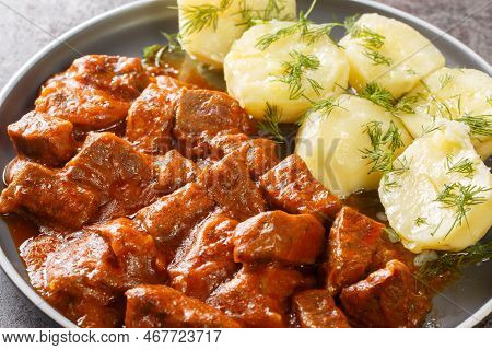 Austrian Beef Goulash In A Thick Rich Sauce With Boiled Potatoes Close-up In A Plate On The Table. H