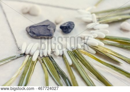 Close Up Necklace With Grass And White Gems Concept Photo. Side View Photography With Light Display 
