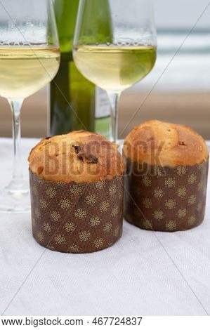 Sweet Fruit Christmas And New Year Cake Panettone With Two Glasses Of Txakoli White Wine Served On S