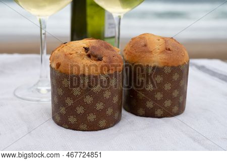 Sweet Fruit Christmas And New Year Cake Panettone With Two Glasses Of Txakoli White Wine Served On S