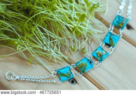 Close Up Blue Craft Bracelets With Dry Flowers Near Sprouts Concept Photo. Side View Photography Wit