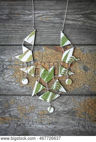 Close Up Stylish Necklace With Green Leaves Concept Photo. Handmade Jewelry. Top View Photography Wi