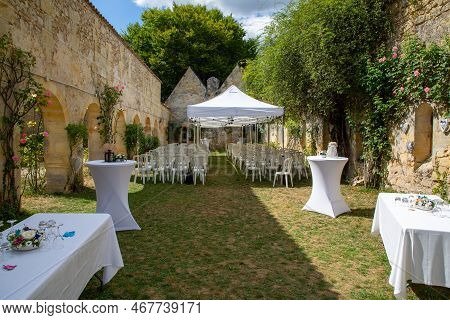 White Empty Chairs Table And Tent On Lawn Ready For Secular Wedding Ceremony