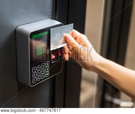 A Woman Opens The Door With A Plastic Card. Modern Keyless Entry Lock.