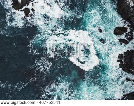 Stormy Sea On A Cold Autumn Day, Top Down View At The Waves Crushing Over The Rocks