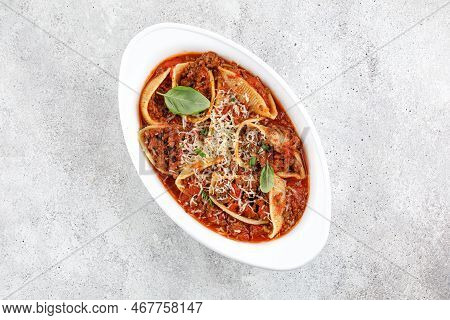 Stuffed Pasta With Bolognese Meat Sauce, Tomatoes, Cheese, Basil. Traditional Italian Bolognese Bake