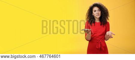 So Waht, I Confused. Questioned Uncertain Woman With Curly Hair In Red Dress Shrugging Looking Cluel