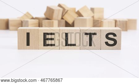 Text Ielts Made Of Wooden Cubes And Different Words On White Background. Concept Of Studying English