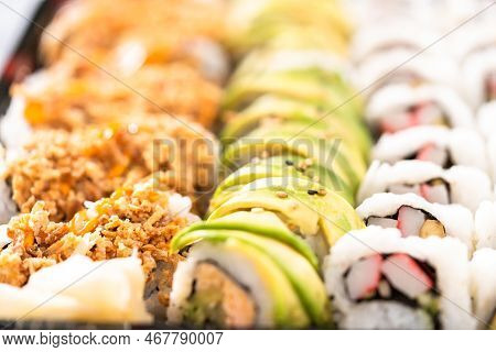 Pre-packaged Variety Of Sushi And Sushi Rolls In A Plastic Tray.