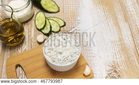 Traditional Greek Yogurt Sauce Tzatziki, Dressing In White Bowl, Made Of Grated Cucumbers, Sour Crea