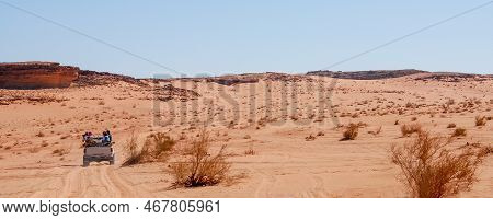 Tourist People On A 4x4 Car Doing   Safari At The Wadi Rum Valley Dry Desert. Jordan Middle East Asi