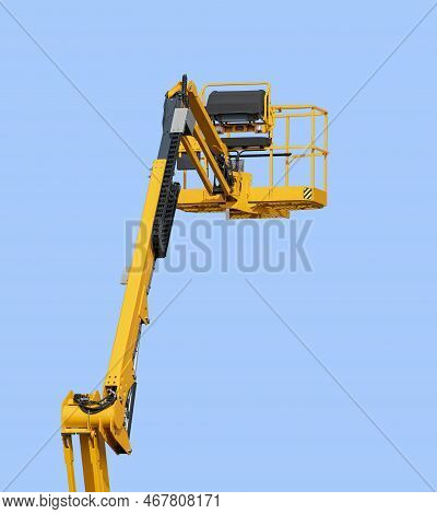 Yellow Aerial Work Platform In Front Of Blue Sky