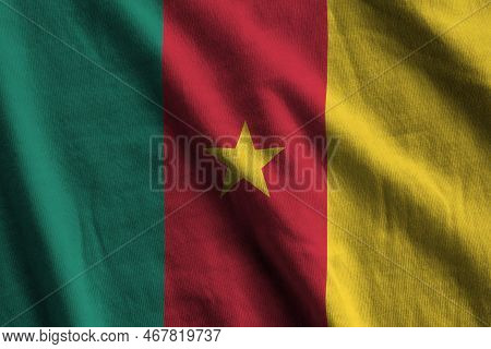 Cameroon Flag With Big Folds Waving Close Up Under The Studio Light Indoors. The Official Symbols An
