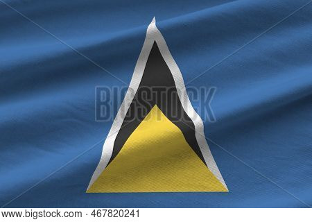 Saint Lucia Flag With Big Folds Waving Close Up Under The Studio Light Indoors. The Official Symbols