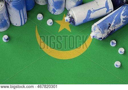 Mauritania Flag And Few Used Aerosol Spray Cans For Graffiti Painting. Street Art Culture Concept, V