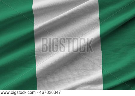 Nigeria Flag With Big Folds Waving Close Up Under The Studio Light Indoors. The Official Symbols And