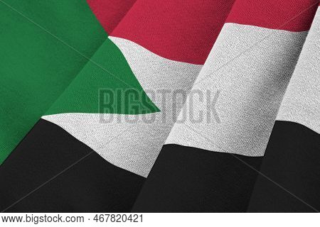 Sudan Flag With Big Folds Waving Close Up Under The Studio Light Indoors. The Official Symbols And C