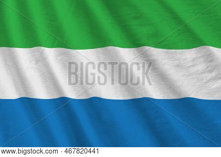 Sierra Leone Flag With Big Folds Waving Close Up Under The Studio Light Indoors. The Official Symbol