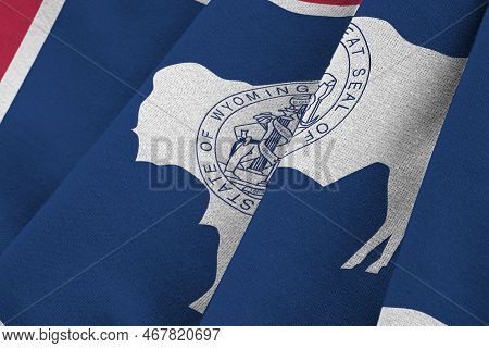 Wyoming Us State Flag With Big Folds Waving Close Up Under The Studio Light Indoors. The Official Sy