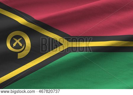 Vanuatu Flag With Big Folds Waving Close Up Under The Studio Light Indoors. The Official Symbols And