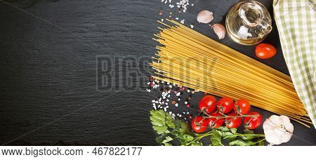 Pasta, Spaghetti And Cooking Ingridients On Black Slate Surface. Italian Cuisine Concept, Restaurant