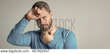 Mature Man With Beard Has Heacache Suffer From Headahce On Grey Background, Malaise. Man Face Portra