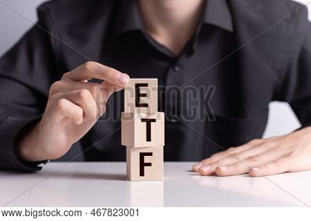 Exchance Traded Fund Investing Concept , A Man's Hand Builds A Tower Of Cubes With Letters Etf