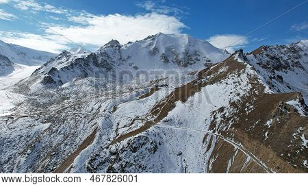High Snowy Peaks And A Small Glaciological Station