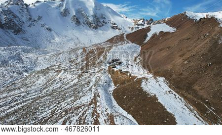 High Snowy Peaks And A Small Glaciological Station