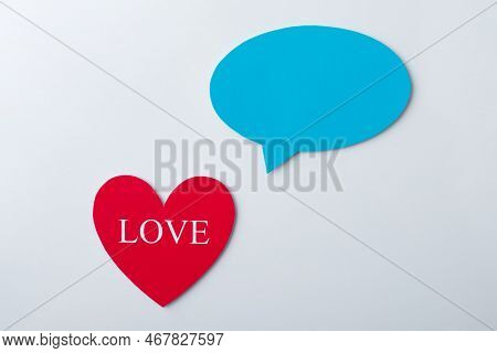 Red Paper Heart With Inscription Love And Blue Cloud Over It On Grey Background. Symbol Of Love