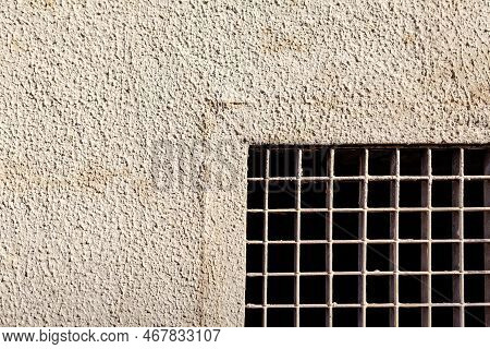 Metal Grating In Stone Wall . Prison Window With Grates