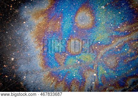 A Puddle Of Spilled Gasoline Or Oil Product On The Road. Environmental Pollution Conceptgasoline Flo