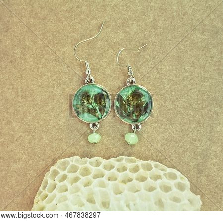 Close Up Craft Earrings With Leaves And Honeycomb Concept Photo. Top View Photography With Cardboard